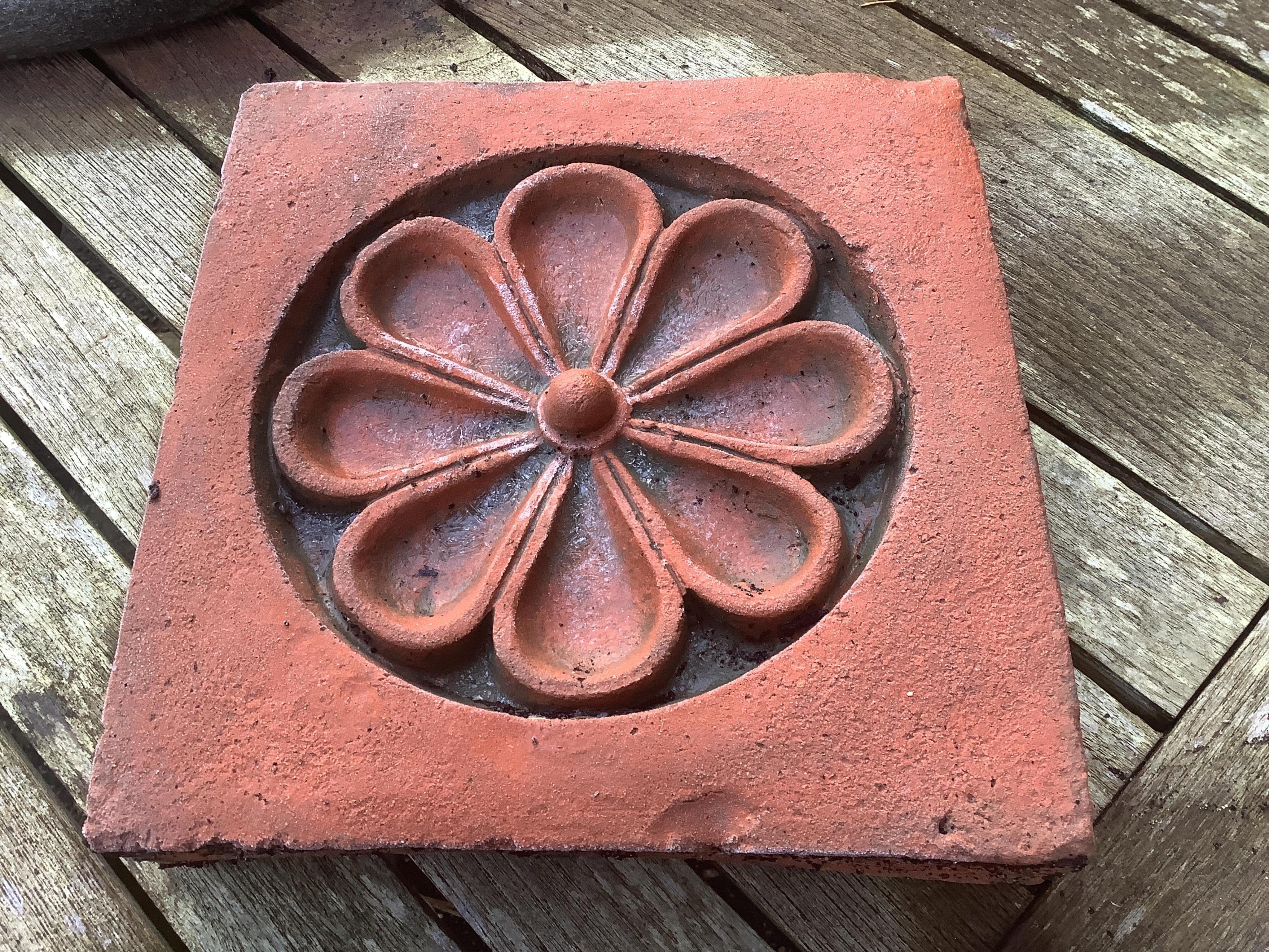 Six terracotta decorative tiles, largest width 21cm. Condition - fair